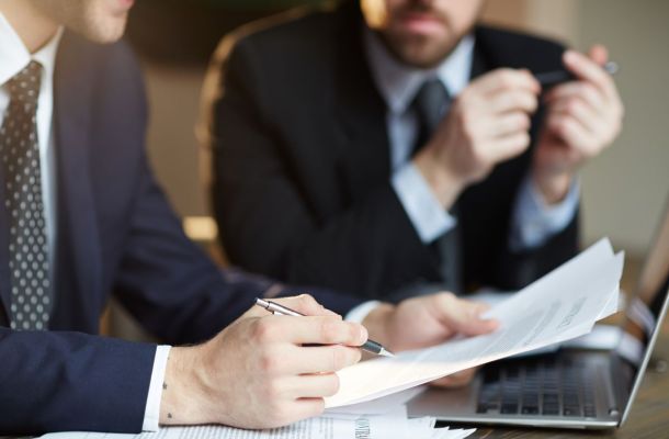 successful business partners discussing contract b545c30b